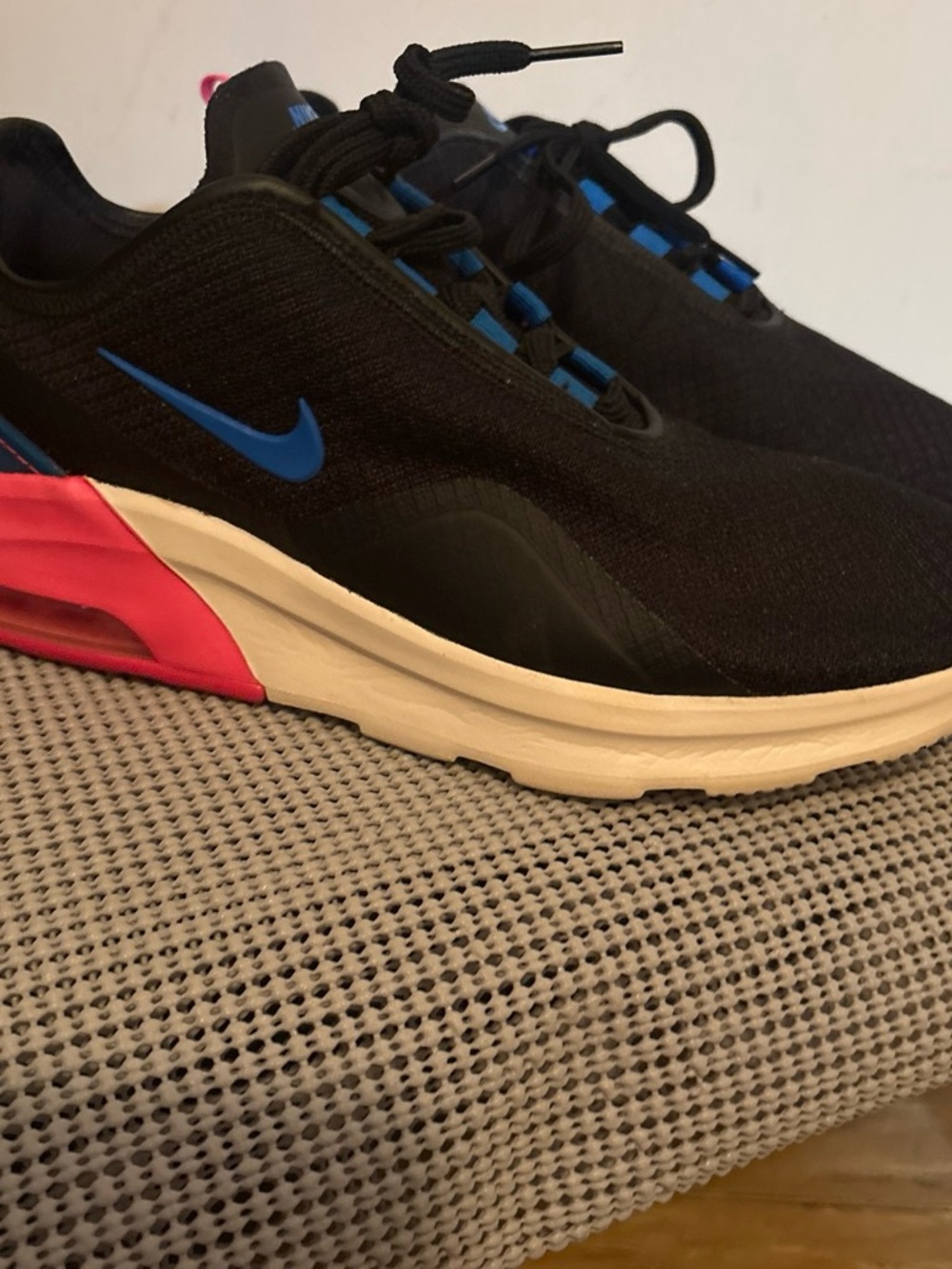 Nike Air Max Motion 2 Black with blue and pink accents.